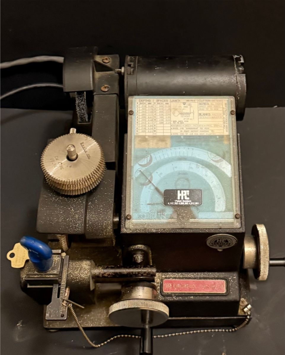 Commercial locksmith cutting BEST keys on a code cutter — master key system service Vancouver WA