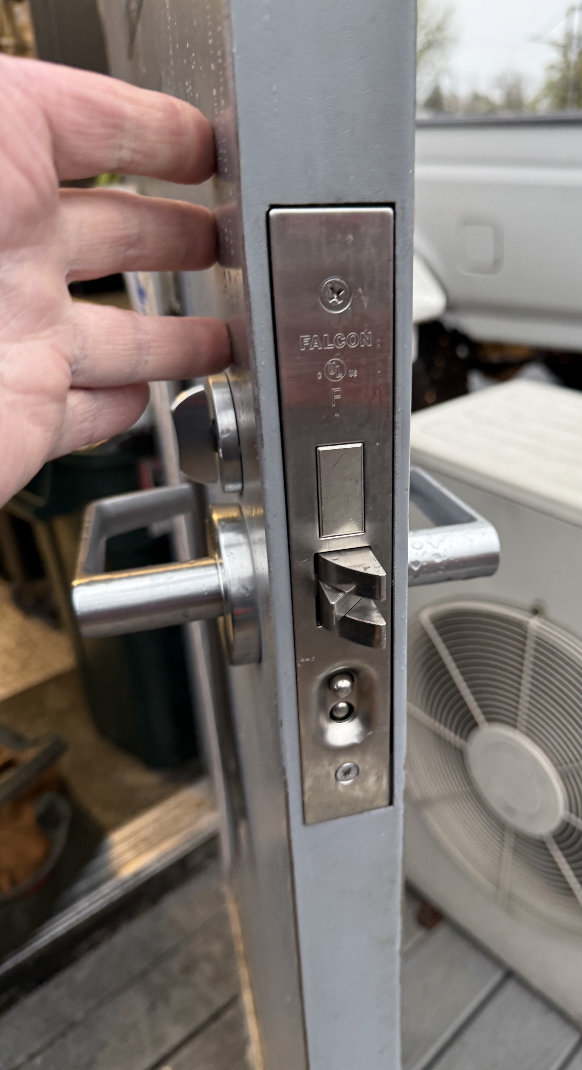 Locksmith adjusting Falcon mortise lock and strike on commercial door — Orion's Key Vancouver WA